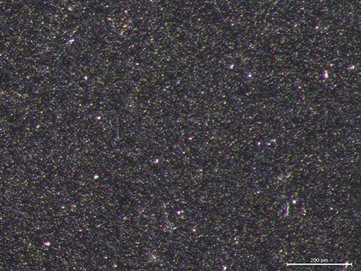 the 34 ct synthetic moissanite shows a very fine-grained homogeneous texture with minute reflecting par ticles.