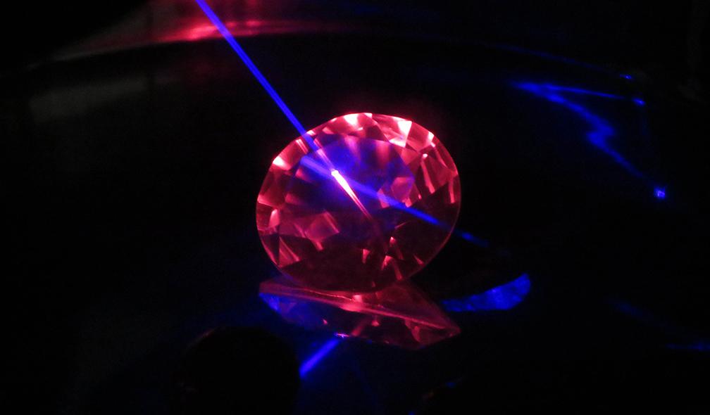 Synthetic flame-fusion colour-change sapphire seen under laser excitation